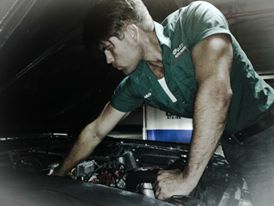 Michael Boryca Jr working under the hood of a car